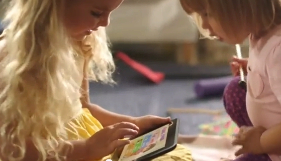 Two children play with a touchscreen Kindle in Amazon's new TV ad